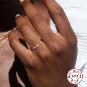 Detailed view of marquise-cut white gems on a gold S925 sterling silver thin ring band