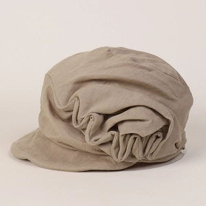 Detailed view of pleated linen texture on a khaki vintage newsboy cap for summer