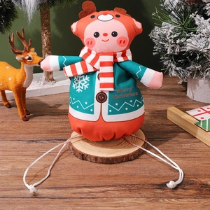 Detail of Christmas gift bag with fabric doll, snowflake prints and drawstring closure