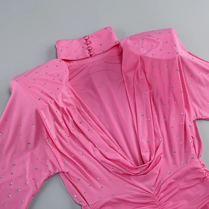 Detail of pink high neck dress showing silver rhinestones and buttoned collar