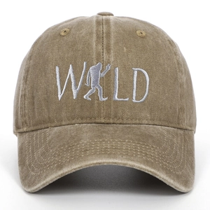 Close-up of khaki washed cotton baseball cap with white WILD Bigfoot embroidery
