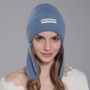 Women's winter blue knit beanie with ear flaps and Short Sentence logo patch