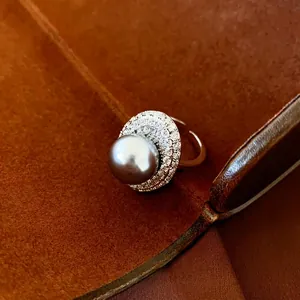 Luxury oval grey pearl ring with sparkling zircon halo on adjustable gold band