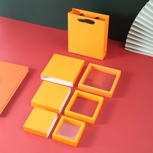 Three sizes of yellow PE film jewelry display boxes with matching paper gift bags