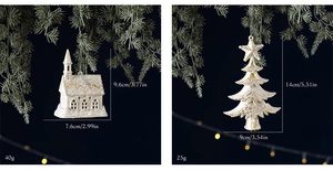 White church and Christmas tree ornaments with gold glitter hanging on a pine branch