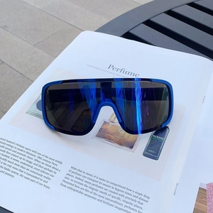 Close-up of blue sports sunglasses with polarized lenses on a book for cycling and hiking