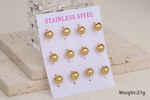 Detailed view of 6 pairs of gold polished stainless steel ball studs on display card