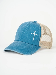 Detailed side view of washed denim trucker hat with embroidered white cross and mesh back
