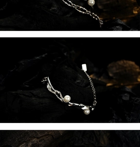 Close-up of S925 sterling silver chain bracelet featuring elegant white pearls on a dark stone
