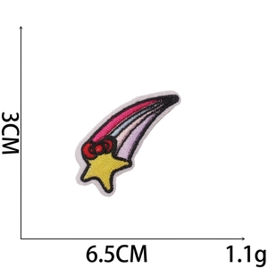 Detail of embroidered shooting star patch with yellow star, red bow, and 3x6.5cm size marks