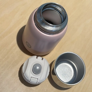 Disassembled pink 316 stainless steel vacuum flask showing inner lid and seal structure
