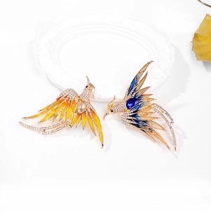 Luxury enamel phoenix brooches in blue and yellow with gold-tone rhinestones