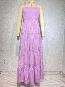 Detail view of pink striped sundress featuring elastic waist and layered tiered skirt