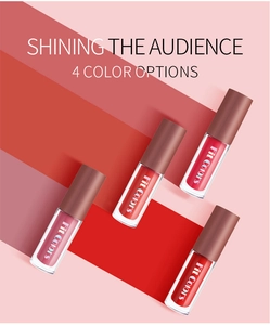 Set of 4 matte velvet lip gloss tubes in diverse red shades on a colorful background