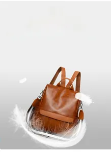 Close-up of lightweight brown faux leather backpack texture with soft decorative feathers
