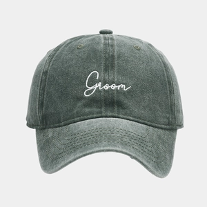 Close-up of white Groom embroidery on washed cotton grey-green baseball cap detail