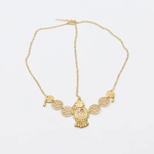 Vintage golden Bohemian head chain with intricate hollow pendants and tassels on white background