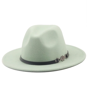 Detail of mint green fedora hat featuring black leather band with silver geometric accents