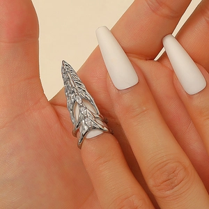Detailed close-up of a silver armor ring with crystals on a hand in a macro view