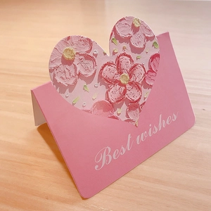Detail of pink 3D greeting card with heart cutout and textured floral oil painting