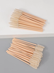 Detailed view of disposable eyelash brushes with pink handles and soft spiral bristles