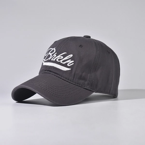 Detailed close-up of dark grey cotton baseball cap with white Brkln letter embroidery
