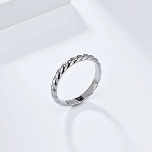 Detailed close-up of a silver twist braided ring with a high-polished metallic finish