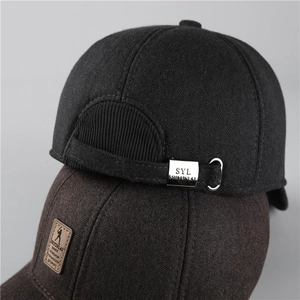 Close-up of winter baseball caps showing textured wool fabric and brown leather logo patch