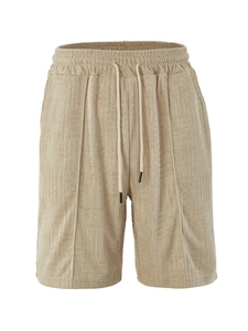 Detailed close-up of khaki terry cloth shorts featuring embossed texture and drawstring waist