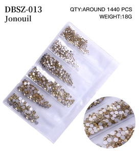 Macro detail of mixed champagne gold flatback rhinestones for nail art and DIY decor