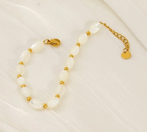 Macro shot of elegant Baroque pearl bracelet with golden spacers and adjustable clasp