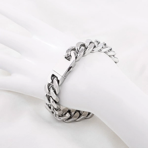 Polished 13mm stainless steel Cuban link bracelet for men on a model wrist