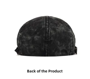 Rear view of washed denim beret featuring adjustable metal buckle and distressed texture