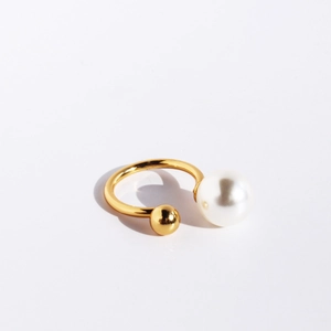 Minimalist gold open U-ring featuring a large white pearl and small golden bead accent