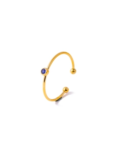 Detailed view of a gold plated adjustable ring with a bezel-set dark blue zircon stone