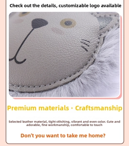 Close-up of grey litchi grain leather and white faux fur on cat keychain