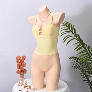 Detail of light yellow camisole with metal ring buckle and pleated texture design