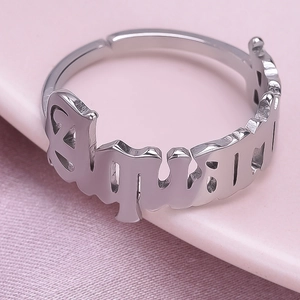 Macro detail of Aquarius hollowed letter design on a polished 304 stainless steel ring