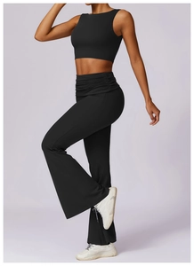 Detail of high-waisted black yoga leggings featuring unique gathered waist design for tummy control