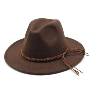Detail view of dark brown wool fedora hat featuring woven band and long tassel accents
