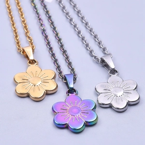 Three minimalist 18k plated stainless steel flower necklaces in gold, silver, and iridescent colors