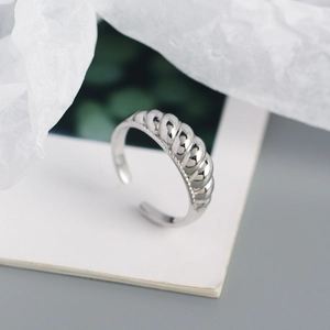 Macro shot of silver croissant ring showing twisted texture and open adjustable band