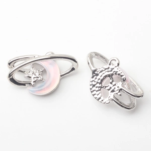 Macro shot of silver moon and star pendant with gradient resin inlay on white background