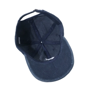 Inside view of navy washed cotton baseball cap showing stitching, sweatband, and metal buckle