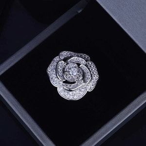 Detailed view of silver rose-shaped pendant with cubic zirconia in a black velvet gift box