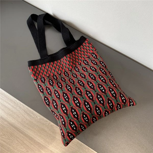 Detailed macro view of the soft knitted texture and retro geometric patterns on the tote bag
