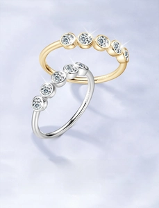 Close-up of gold and silver S925 sterling silver rings with five moissanite stones