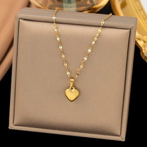 Goldene Herzkette mit feiner Kette präsentiert auf einer champagnerfarbenen Box
