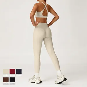 Women's cream nude-feel yoga set with racerback sports bra and high-waisted side pocket leggings