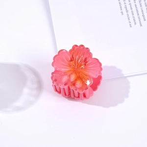 Detail of pink hibiscus hair claw clip with glossy finish and translucent gradient texture